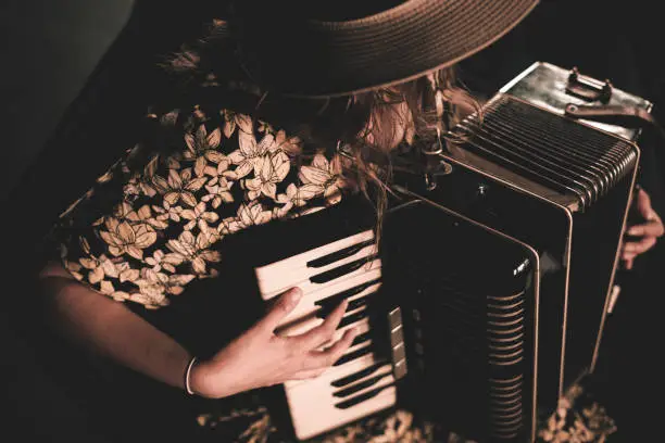 Woman playing the accordion. Close up.