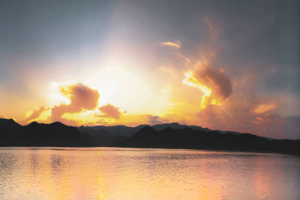 Sunset Over Moomaw Lake (Bath County) Virginia An abstract image of a peaceful moomaw lake in the evening. There are strange formations of clouds in the sunset sky. The mountains (from the Gathright Wildlife Management Area) are rising up to meet the clouds. It is part of the George Washington and Jefferson National Forest. Copy space. george washington national forest stock pictures, royalty-free photos & images