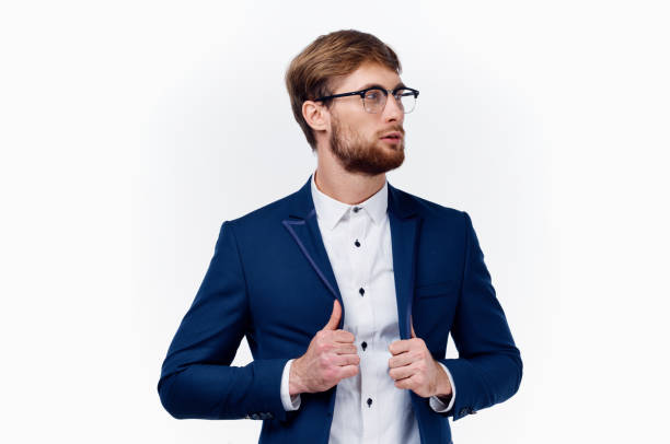 istock blond man in classic suit straightens jacket sleeve cropped view 2115809861