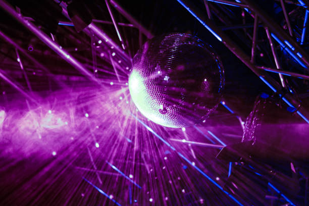 istock Shining disco ball with purple lights. 2115811415