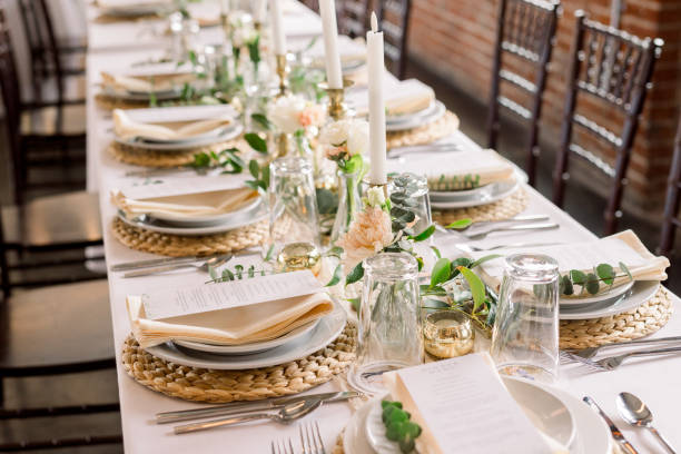 istock An elegant formal dining table decorated with macrame chargers, white plates, napkins, glasses, candlesticks. 2115820760