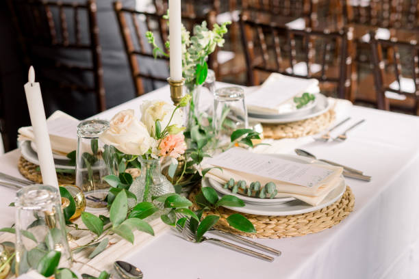 istock An elegant centerpiece on the head table at a wedding reception with greenery and plates and silverware 2115831502