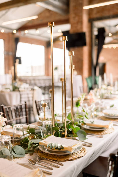 istock A modern wedding reception with beautiful table details including candlesticks, green garland and florals on the table. 2115837630