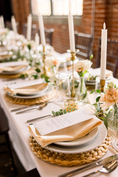 istock Pretty table setting details at a wedding including candlesticks, pretty florals, and napkins 2115842756
