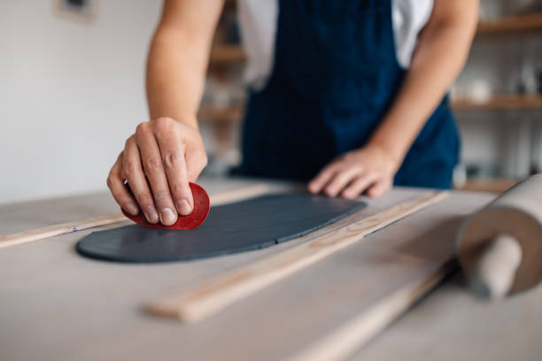 istock Close up of craftswoman's hands working with clay at ceramics studio. 2115849076