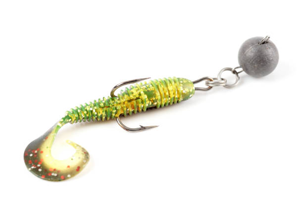 istock Soft fishing bait for predatory fish, moss green plastic grub, with double hook and lead sinker, isolated on white 2115850464