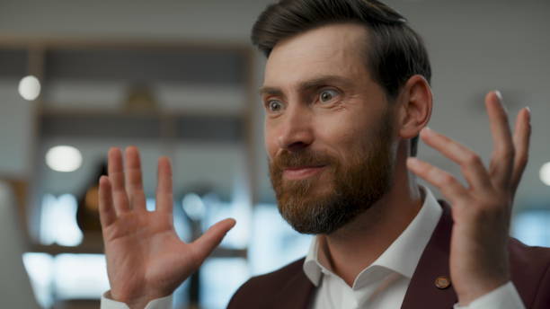 istock Euphoric businessman emotionally gesturing at office building. Triumph concept 2115851580
