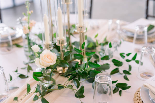 istock A beautiful table at a wedding reception decorated with garlands, roses, and candles 2115853341