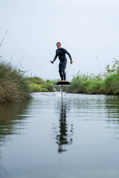 istock Hydrofoil rider gliding over the water 2115910349