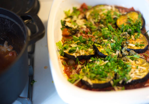 Tomato Sauce in Pan Next to Eggplant Parmigiana