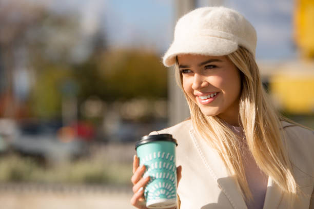 istock Sunlit Serenity: Joyful Woman Savoring Coffee 2115950157