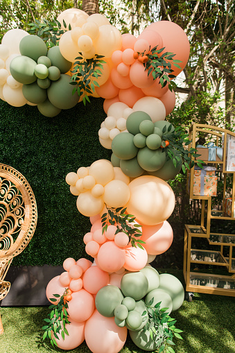 Coral & Sage Green Ballon Arch Art Display at a Spring Garden Party in Palm Beach, Florida in March of 2024