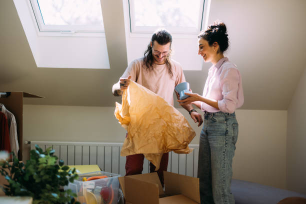 istock Young Couple Unpacking Boxes in Sunny New Home, Moving Day 2115960855