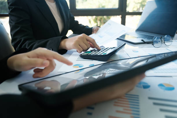 istock Two people are working on a spreadsheet with a calculator 2115962036