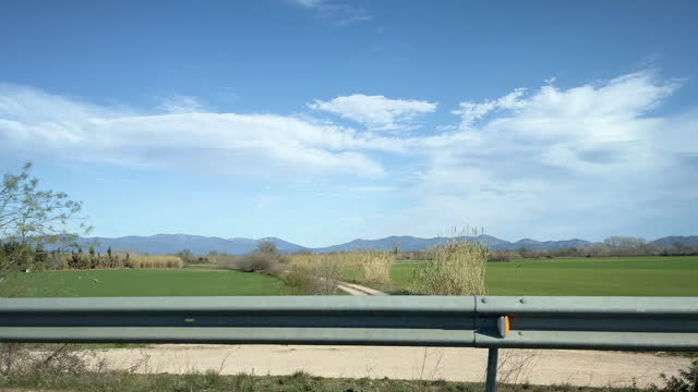 Car point view of Catalonia fields with the Pyrenees at the background