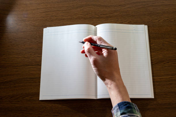 write something with a pen on a white notebook