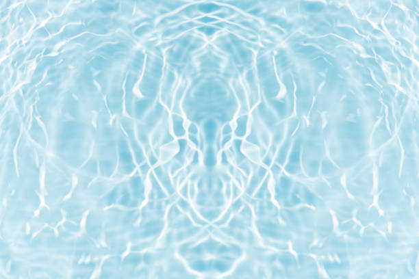 Blue water surface texture with ripples, splashes, and bubbles. Abstract summer banner background Water waves in sunlight with copy space cosmetic moisturizer micellar toner emulsion. Blue water wave.