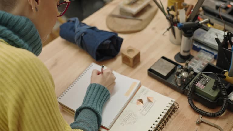 Woman drawing at jewel design class