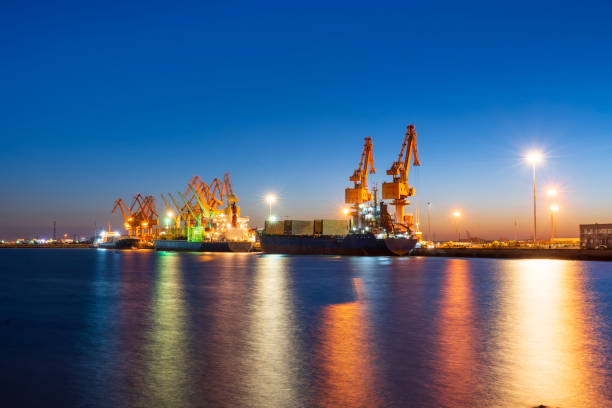 istock Gantry crane and cargo ship in the evening, Shipping and logistic concept 2116048434