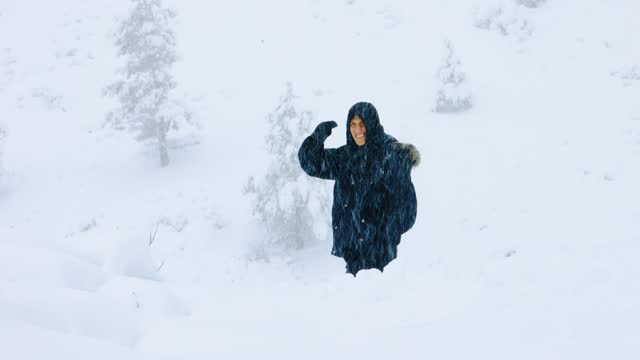 Man Standing and Smiling in Crazy Snowstorm in Colorado Rocky Mountains