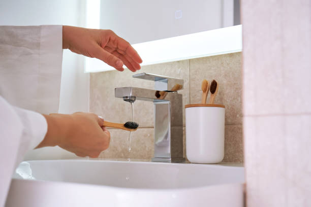 istock Women's hands under running water in the bathroom. Morning routine. 2116124252