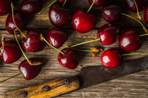 istock Freshly harvested ripe cherries on the dark rustic background 2116173772