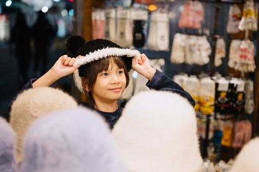 Shibuya, Tokyo / Japan - May 5th, 2014: Image of takeshita street where two kawaii cute anime-like teens dress like dolls and hold a discount display to call customers attention to the store