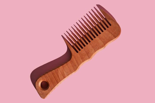 istock Wooden comb on a pink polka dot background. 2116194846