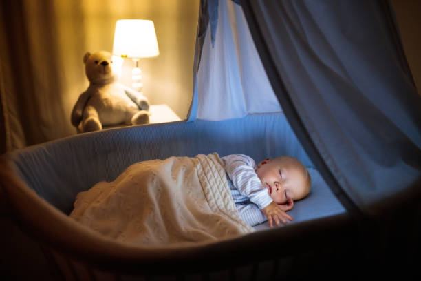 istock Baby boy in bed sleeping at night 2116314695