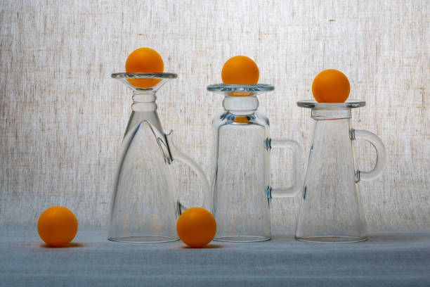 Still life with glassware  and orange balls