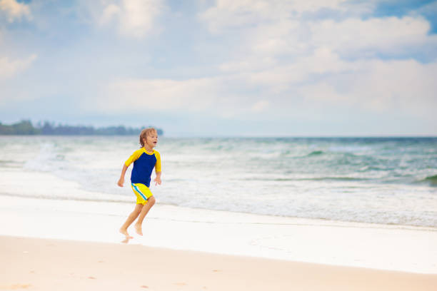 American boy frolics, bathes and swims in the sea. Plays in the spray of sea waves.