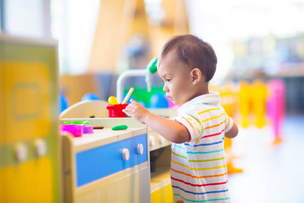 Cute baby boy in kindergarten or daycare.