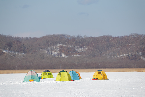 Feb 09, 2024 Onbetsu, Hokkaido, Japan
Tents on frozen lake used by fishermen for winter ice fishing