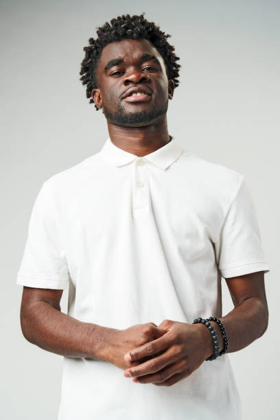 istock Man in White Shirt Standing With Hands Together 2116412929