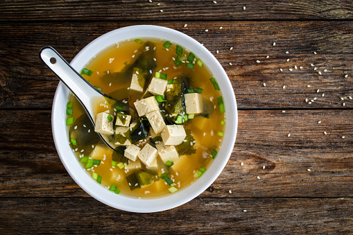 Miso soup - traditional Japanese soup with tofu on wooden background