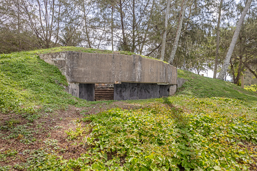 Longues-sur-Mer, France - Apr 26, 2024: German Longues-sur-Mer battery during Second World War. It is the only one in the region to have kept its guns. Rainy spring day. Selective focus