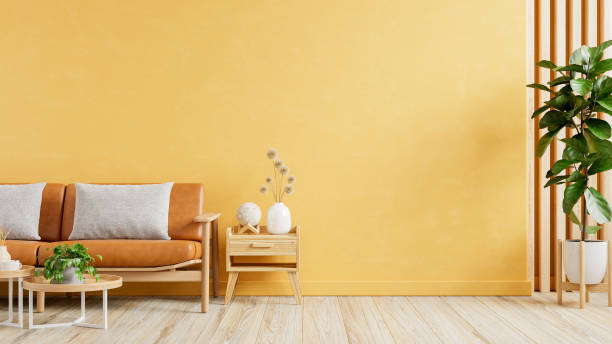 istock Living room wall mockup with leather sofa and decor on yellow wall background 2116432078