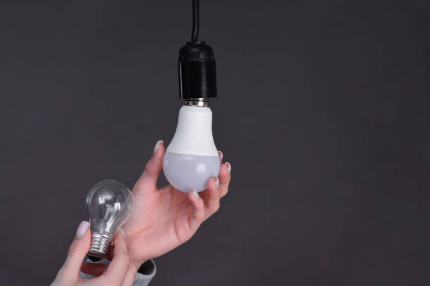 istock the concept of energy saving. replacing the incandescent light bulb with LED 2116447962