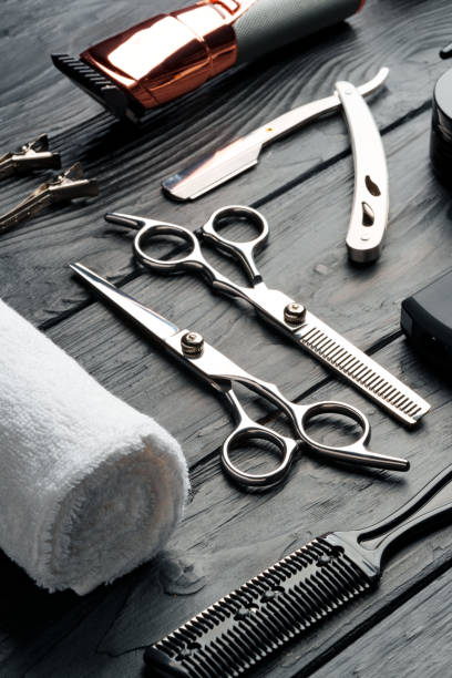 istock Professional Barber Tools Laid Out on Dark Wooden Surface 2116472460
