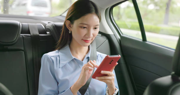 istock woman sit taxi use mobile 2116495222