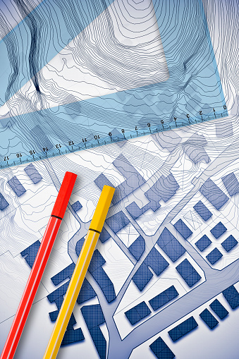Plastic set square with red and yellow marking pen over an imaginary cadastral map of territory with buildings, fields and roads - 3D rendering concept image