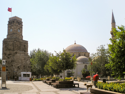 Antalya, Turkey, August 08, 2007 : One of the many mosques and the tall stone Saat Kulesi watchtower with clock in the old city of Antalya in Turkey