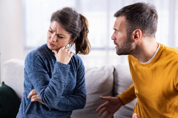 istock Mid adult couple arguing on sofa at home. 2116552260