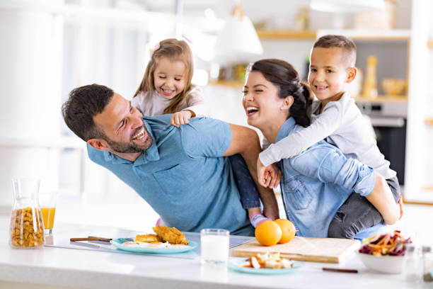 istock Cheerful family having fun in dining room. 2116552353