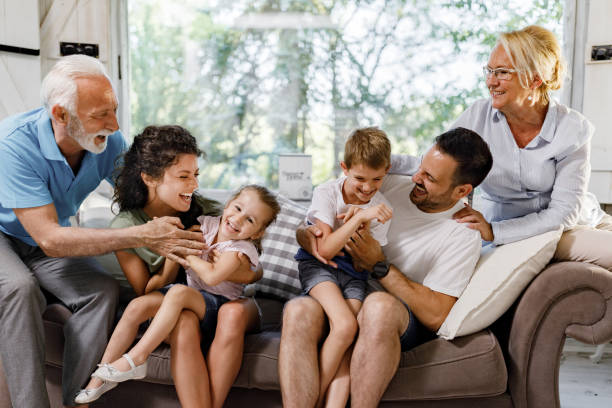 istock Playful extended family having fun on sofa at home. 2116552669
