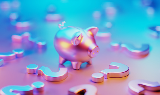 Metallic piggy bank illuminated by pink and blue lights  in the midst of question marks on blue and pink background. Horizontal composition with copy space.