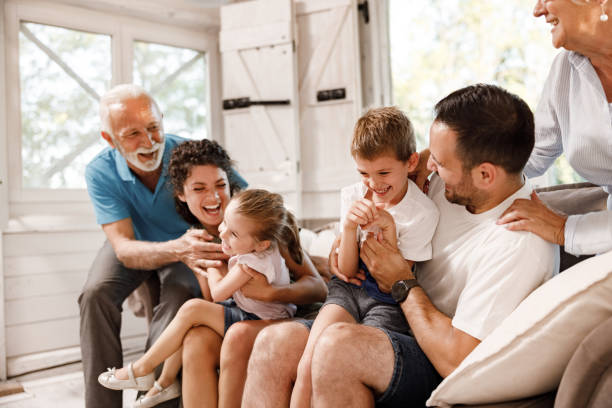 istock Playful extended family having fun on sofa at home. 2116553042