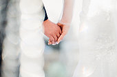 The bride and groom holding hands at the wedding ceremony venue