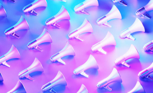 istock Metallic Megaphones Illuminated By Pink And Blue Lights On Blue Background 2116556793