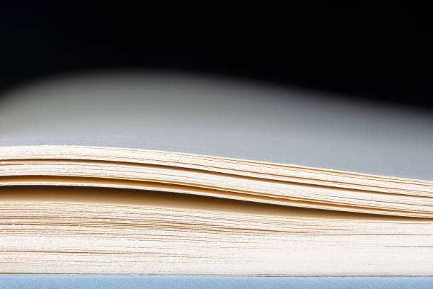 istock Book pages with toned dark background 2116585797